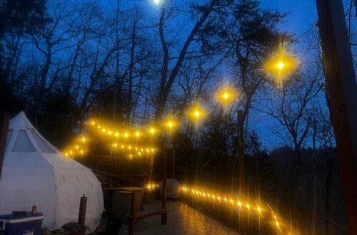 campsite at night with string lights